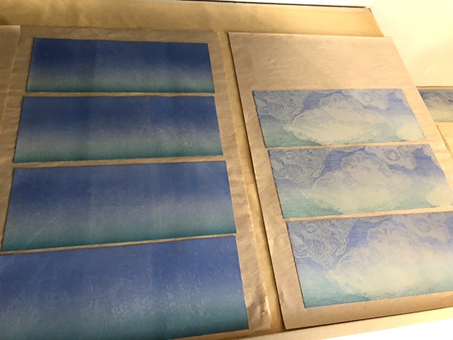 The cloud woodcut is being printed on top of the rainbow roll