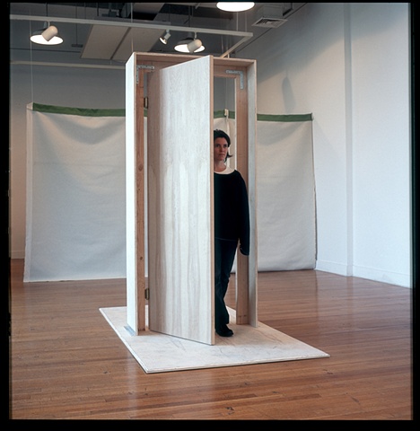 The participant comes in or out through the swinging door, physically and symbolically demarcating space and state of mind