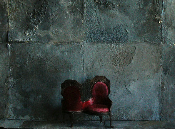 Model: Half inch Victorian Chair against cement.