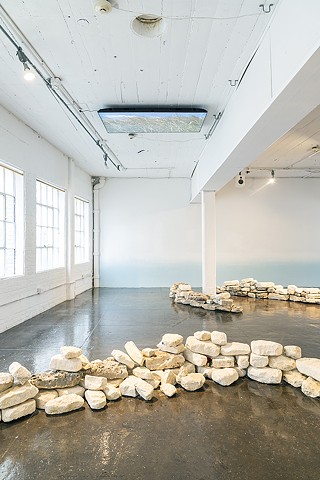 Installation view of limestone and video
