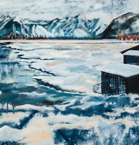 Detail of snowy and cold looking landscape with distant mountains and mysteriously dark structures in foreground.