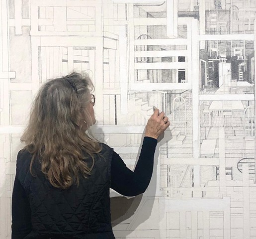 Sheila Ghidini drawing on the gallery wall during the installation of From Here to There.