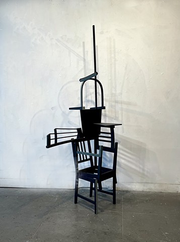This is a sculpture constructed from reconfigured wood chairs and paint.