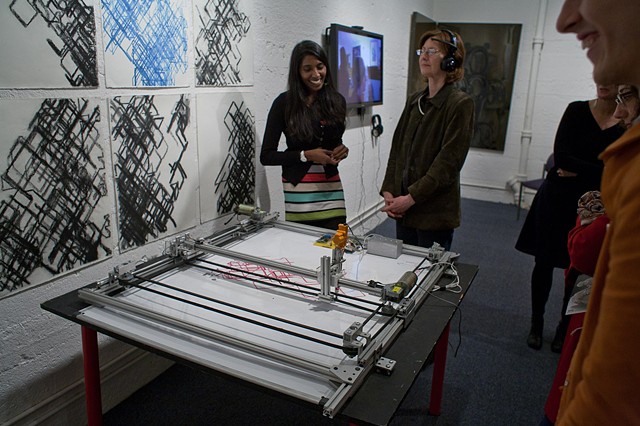 Santhi Elayaperumal demonstrating "RedGreenBrain" her brainwave-driven robotic drawing machine