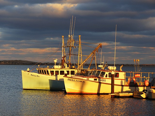Sunset reflected on boats in Provincetown Harbor, Provincetown, MA © Sally Brophy