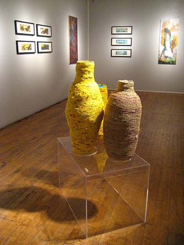 Closer up angle of vessels with paintings in the background.