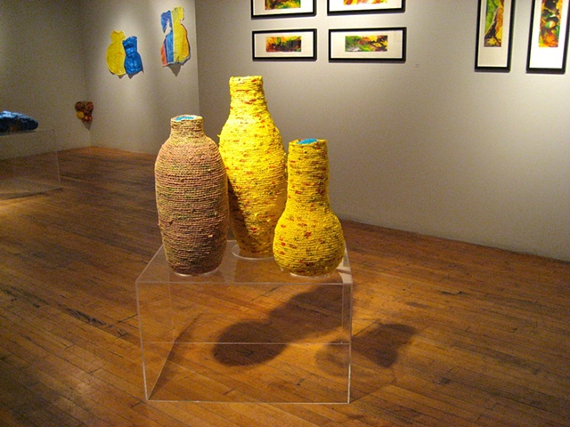 Closer photo of vessels with other works in the background.