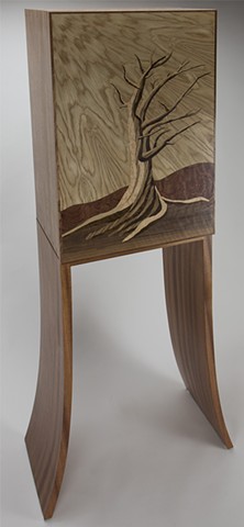 Three quarter view of marquetry cabinet