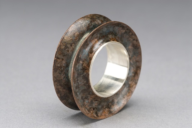 Concave die-formed ring w/ silver and copper.