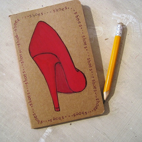 Red Stiletto Shoe decorating the cover of a hand illustrated Moleskine Notebook, by Brighton artist, Linda Boucher