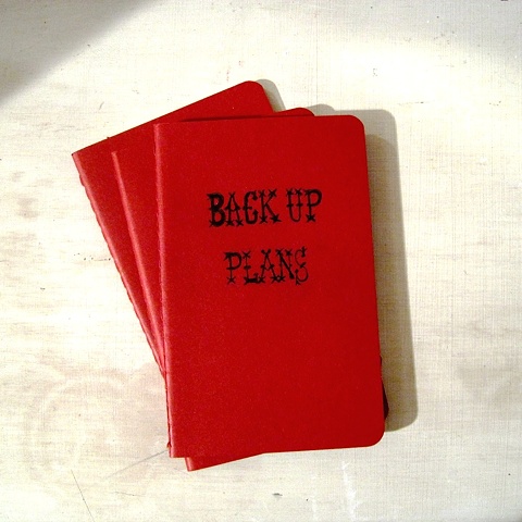 Deep red Moleskine Notebook with personalised title hand written by Linda Boucher working from her Brighton studio