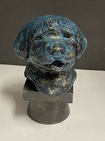 Small sculpture of golden retriever puppy