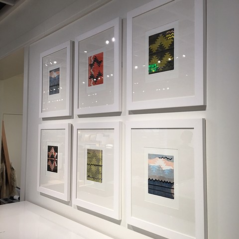 A grouping of framed prints on a wall