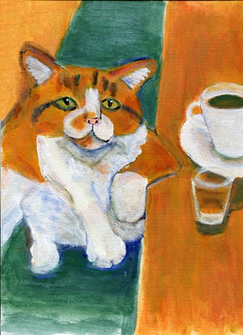 Orange and white tabby next to a cup of coffee and a shotglass.