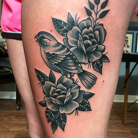 black and grey bird and flowers tattoo thigh