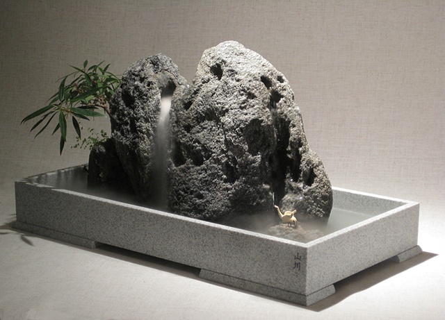 zen indoor fountain rock sculpture with waterfall and bird figure