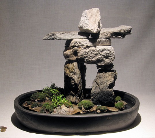 miniature innunguaq fountain of feather rock with centaurium, mosses, and fogger
