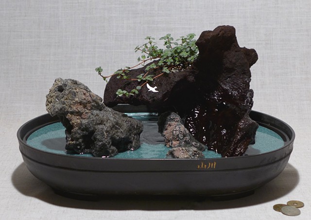feather rock fountain with live plant, waterfall, driftwood, reclaimed Corian, and handmade bird figurine