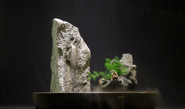 zen indoor fountain rock sculpture with plant and chinese figurine