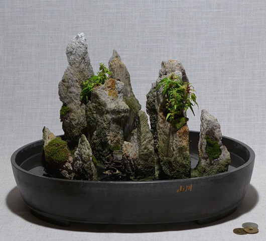 feather rock fountain with live plants and ceramic miniatures