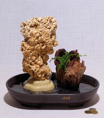 spaghetti rock fountain with Malaysian driftwood and oakleaf fig