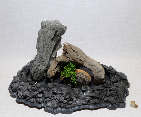 feather rock fountain with driftwood, miniature cranes, and Corian base