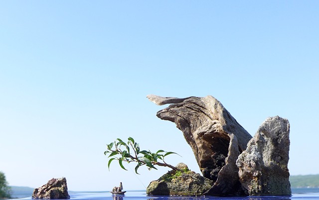 Corian suiban with driftwood, feather rock, fountain, and mudman boat