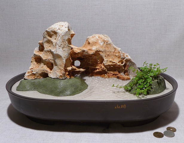 Honeycomb limestone fountain with live plant