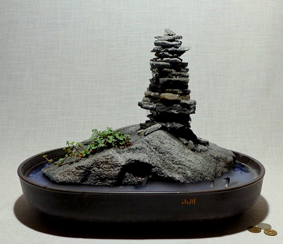 feather rock fountain with inuksuk, live plants, and handcarved bird miniatures