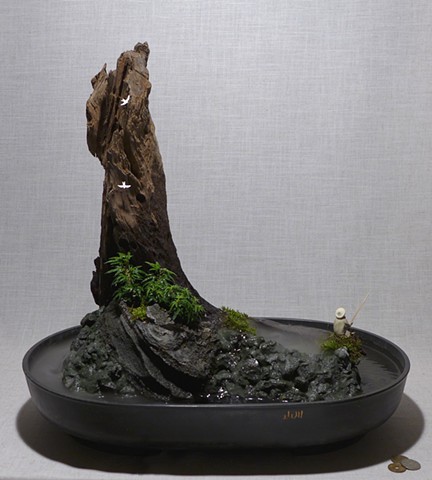 feather rock fountain with dwarf English ivy, fogger, and miniatures