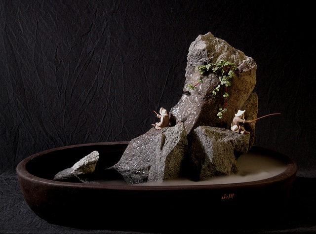 zen indoor fountain rock sculpture with ferns, fogger, and chinese figurines
