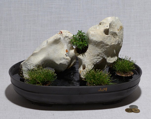 Tabletop fountain of holey limestone with live plants and miniatures 