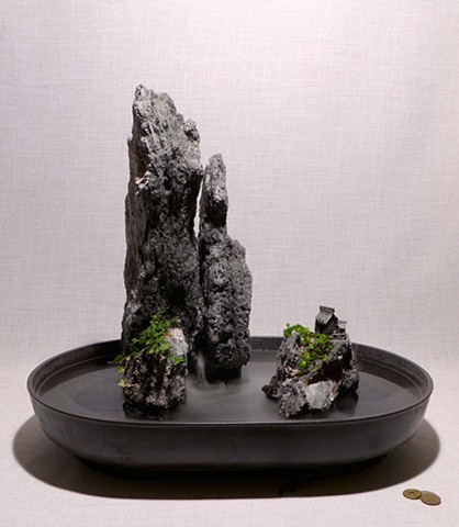 tall feather rock fountain with fogger, plants, and mudman figures