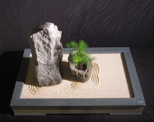 zen indoor fountain rock sculpture with plant and simulated raked stone