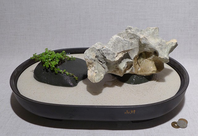 tabletop fountain with limestone, pump, and live plant