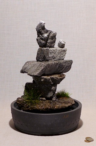 Inuit fountain sculpture with grasses 