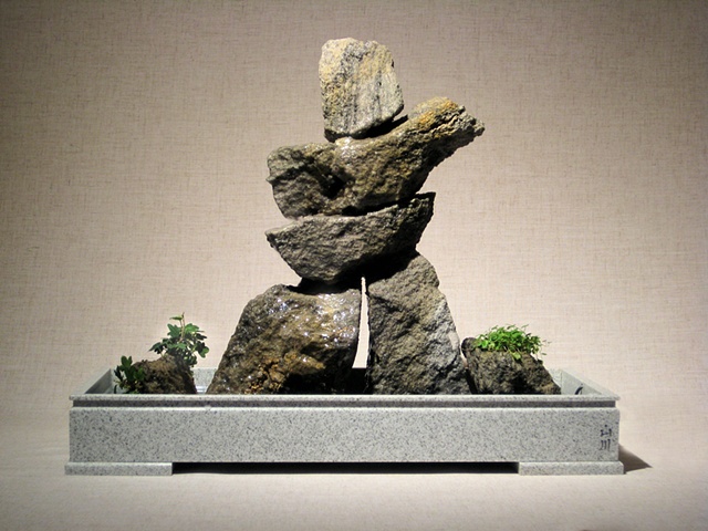 indoor inuksuk stone fountain with ivy