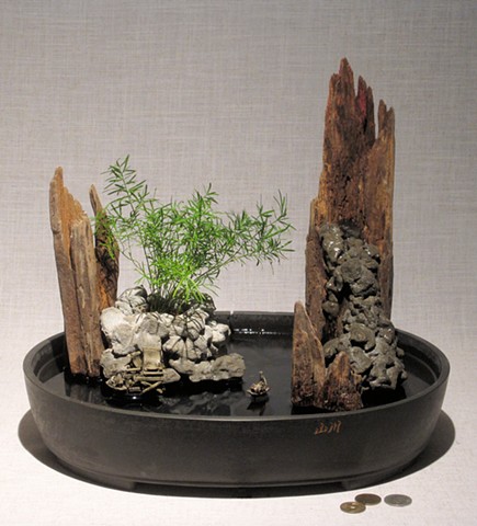 miniature seascape with waterfall, ming fern, and ceramic figurese