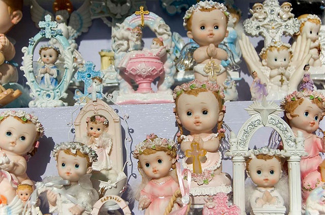 Religious pastel angels and dolls in the window of a store in Milwaukee avenue photographed by lucy mueller