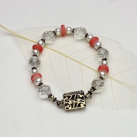 coral rondels compliment the faceted quartz and pearls in this 7" bracelet, accented with Bali silver beads and finished with an open work sterling box clasp (#559B)
