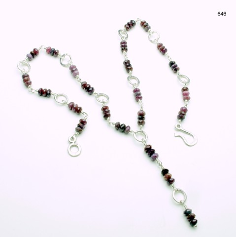 "Y" necklace of hammered silver rings w/ wire wrapped faceted ruby rondelles, s/s hook & eye clasp, (22" w/ 2" drop) (#646)
for coordinating earrings, see # 646E 
