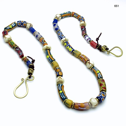antique millefiori glass beads from Ghana on a leather cord, accented w/ Nigerian brass beads & carved horn beads, finished with a brass clasp (32") (#651)