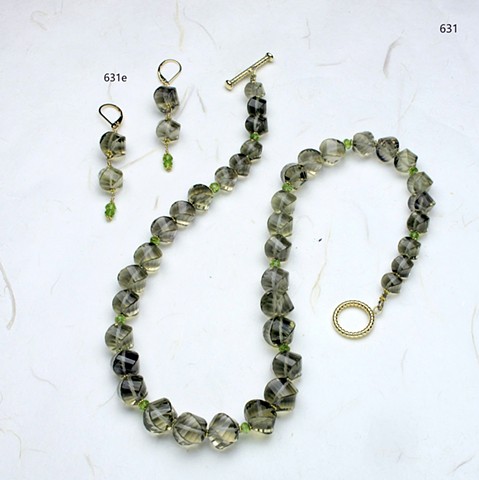 unusually faceted spiral cut smoky quartz accented with faceted peridot rondels and vermeil spacers, finished with a g/f toggle clasp (#631) coordinating earrings are no longer available