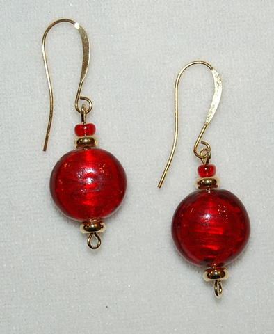 Red disc shaped murano style glass earrings accented with gold tone spacer  