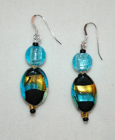 Earrings of black oval glass wrapped with aqua and amber foil, a large round aqua murano-style glass bead with black and amber seed bead accents on Sterling Silver French ear wires
