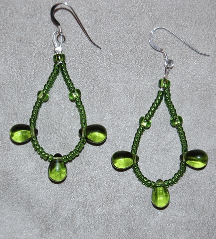 Earrings of Olive green glass teardrops with olive green glass seed beads looped on Sterling silver French ear wires