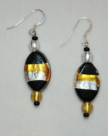 Earrings of black oval glass fused with silver and gold foil, accented with murano style gold and silver beads