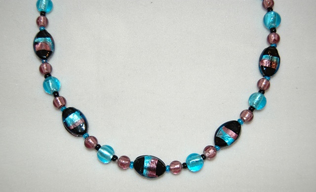 Necklace of black oval glass beads wrapped with aqua and amethyst foil and round amethyst murano-style glass beads