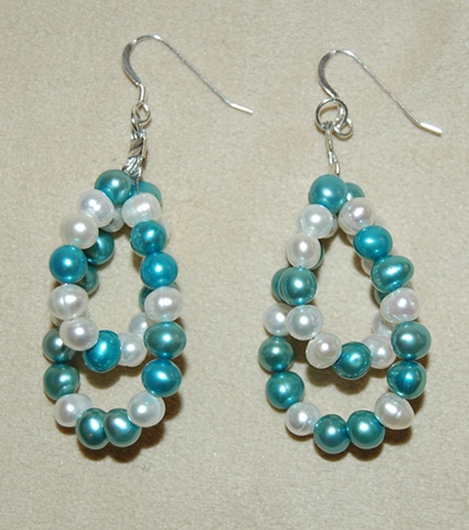 Double-looped earrings of freshwater pearls alternating in white and jade green on Sterling silver French ear wires.