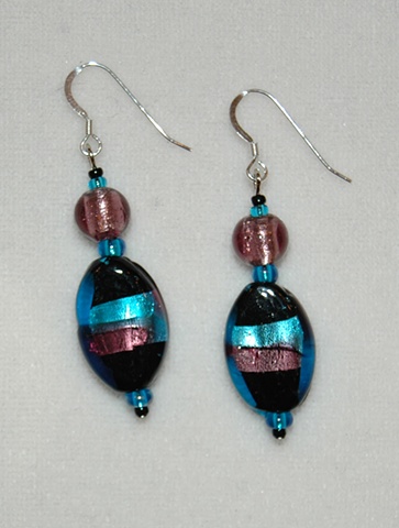 Earrings of black oval glass wrapped with aqua and amethyst foil, a round amethyst murano-style glass bead 